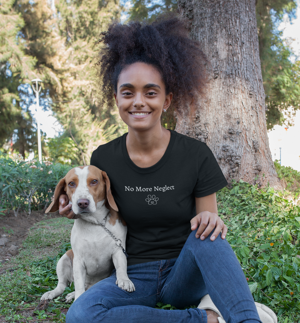 Woman sitting outdoors with a dog, wearing a black t-shirt with 'No More neger' text.