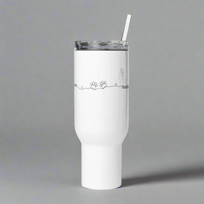 White tumbler with a straw on a gray background