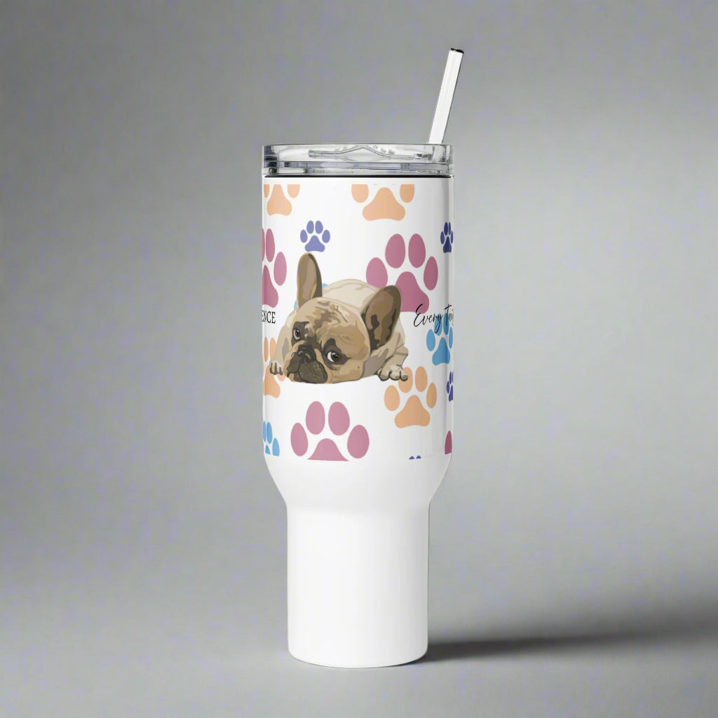 White tumbler with a dog design and paw prints on a white background