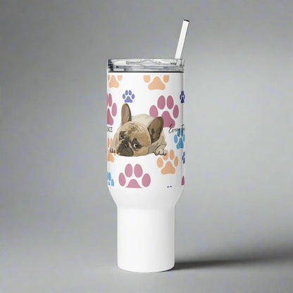 White tumbler with a dog design and paw prints on a white background