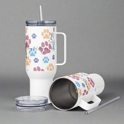 Tumbler with colorful paw prints and text on a white background