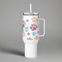 White tumbler with colorful paw prints and a handle on a gray background