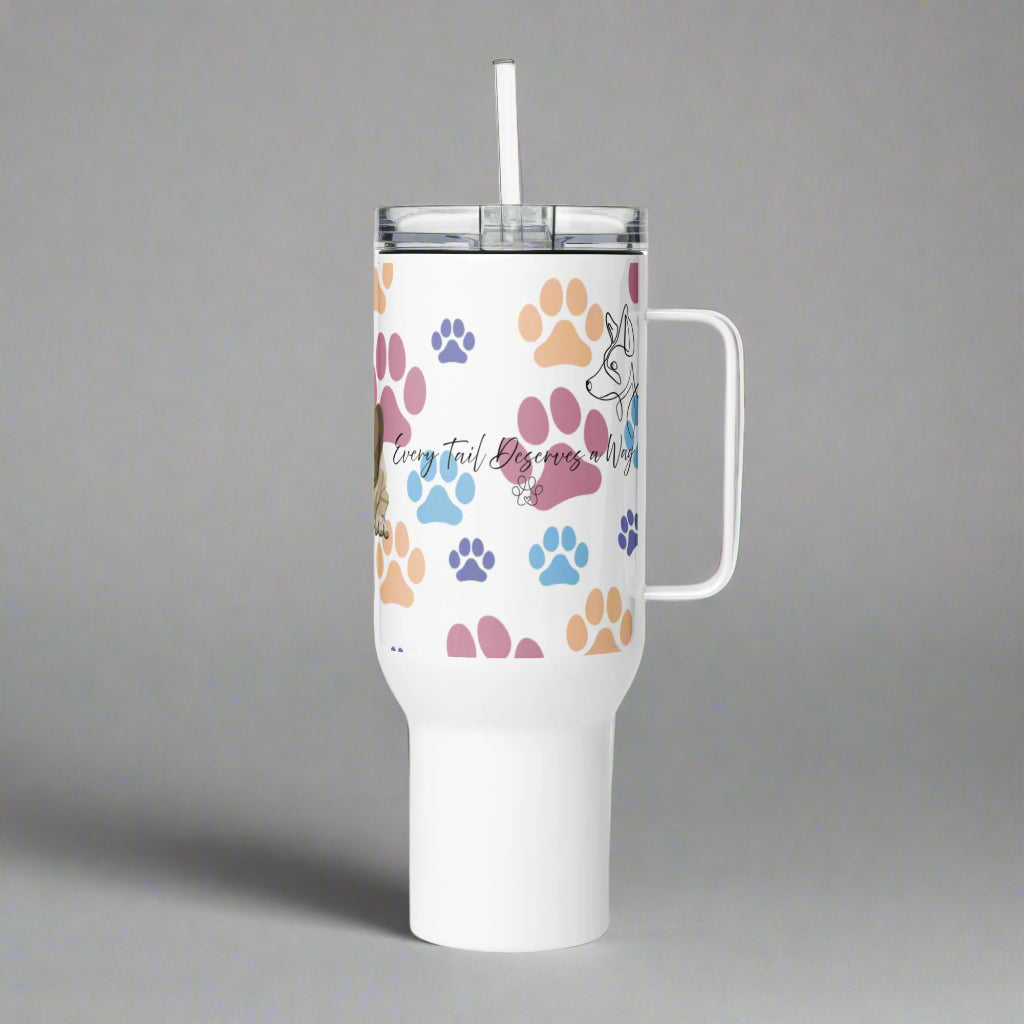 White tumbler with colorful paw prints and a handle on a gray background