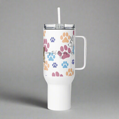 White tumbler with colorful paw prints and a handle on a gray background