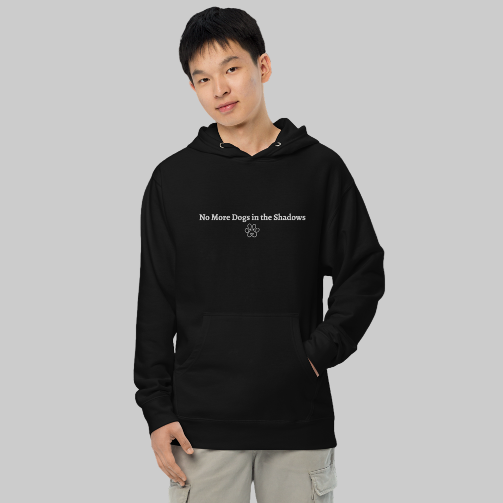 Person wearing a black hoodie with text and paw print design on a gray background