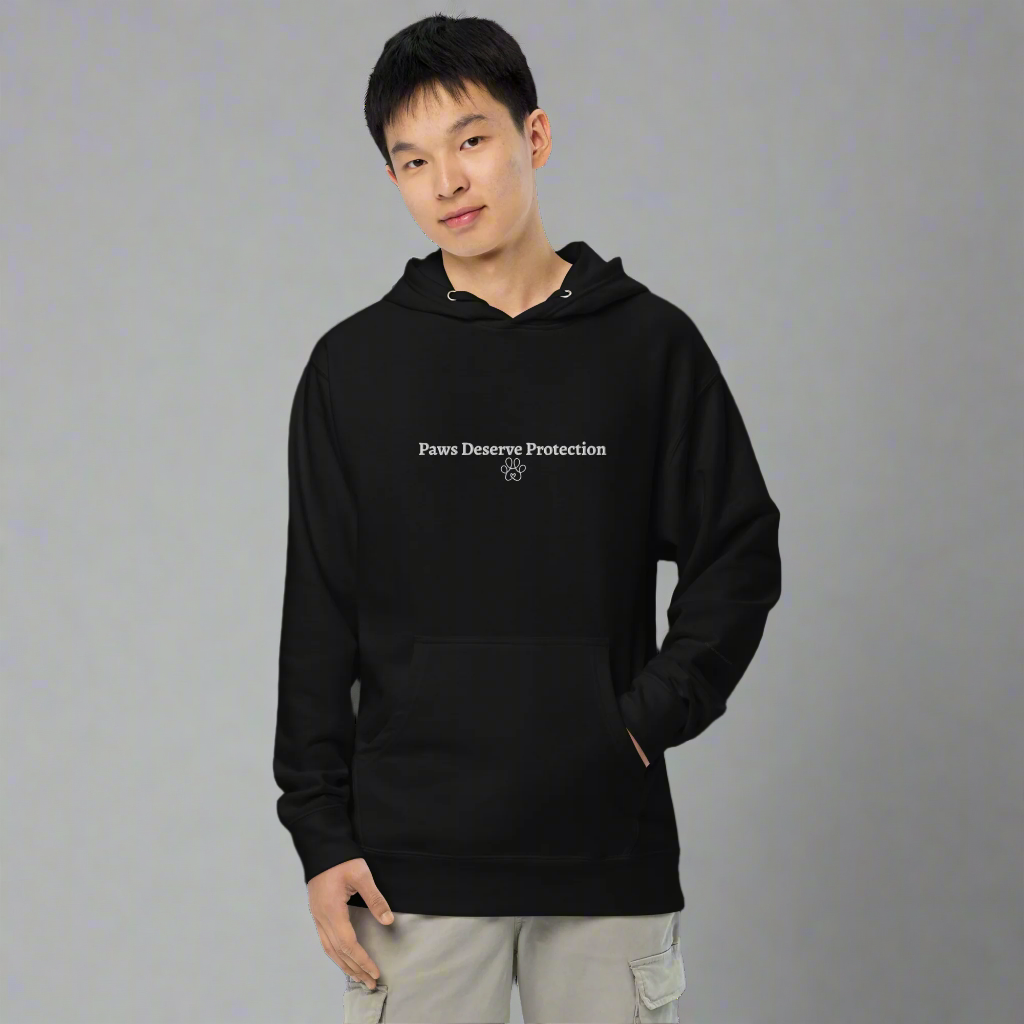 Person wearing a black hoodie with text on a gray background