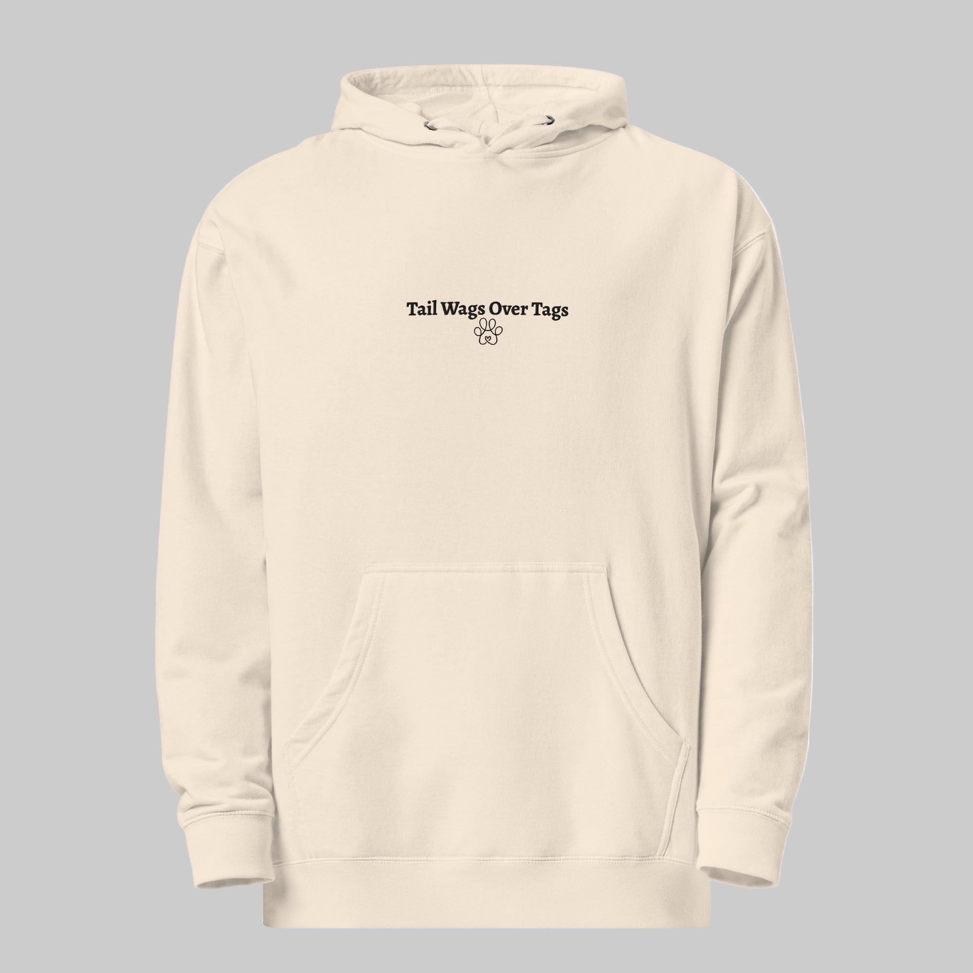 Beige hoodie with text 'Tail Wags Over Tags' on a white background