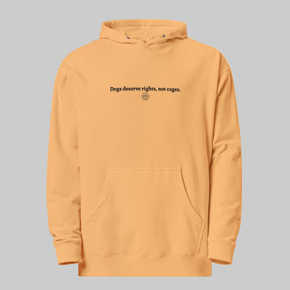 Yellow hoodie with text 'Dogs Deserve Rights, Not Cages' on a light gray background